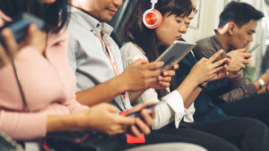 A group of people sending bulk text messages.