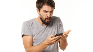 A man bewildered by the fact he keeps receiving spam text messages.