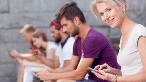 A woman is consenting to receive mass text messages while on her phone.