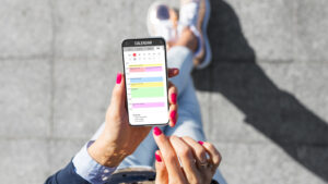 A woman checking her calendar to figure out when to schedule her mass text messages.