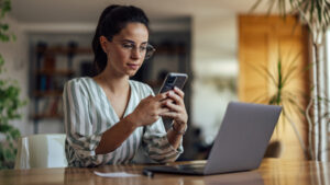 A woman scheduling text messages on her phone using TextSanity.