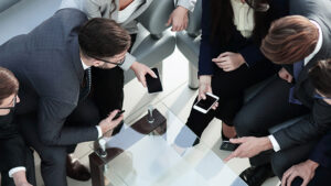 A group of employees receiving a reminder text message for an upcoming meeting.