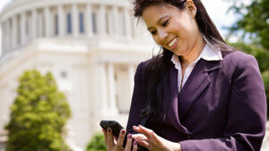 Government employee outside of a government building texting. 