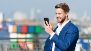 A property manager looking at a potential clients information via sms on his mobile phone. 